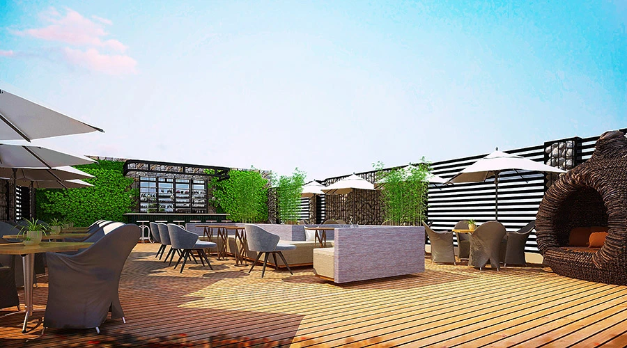 Terrazza outdoor aziendale con sedute lounge, tavoli, ombrelloni e pareti verdi, progettata per favorire benessere, socializzazione e momenti di pausa all'aperto.